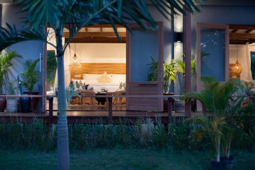 a house with a porch with a bed in it at Pondok Santi Estate in Gili Trawangan