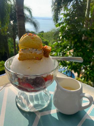 a plate of desserts on a table next to a cup of coffee at Villas by Eco Hotels in Mataasnakahoy