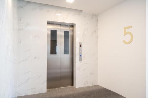 a elevator in a building with the number six at Diya Hotel Bangkok in Amphoe Phra Khanong