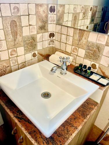 a white sink in a bathroom with a counter at Martins Crest in Patnem
