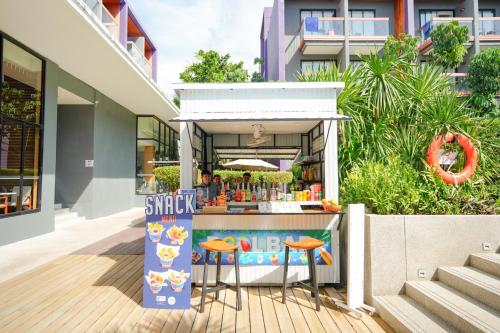 a food stand with stools in front of a building at Holiday Inn Express Phuket Patong Beach Central by IHG in Patong Beach