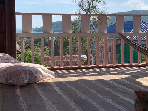 a porch with a hammock on a deck at DAHLIA Guesthouse in Koh Rong Sanloem
