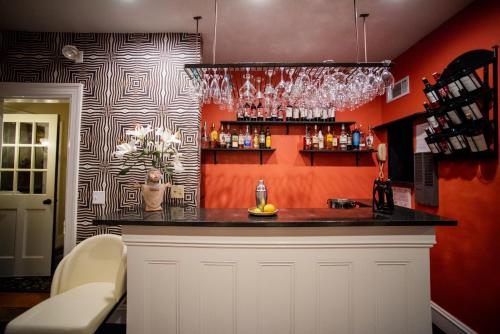 a bar in a room with orange walls at Lindenwood Inn in Southwest Harbor