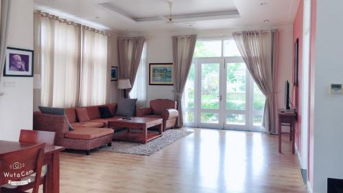 a living room with a couch and a table at Sealink Beach Villa PE48- PE69 in Ấp Bình Hưng