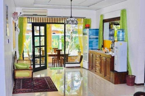 a room with a kitchen and a dining room at Aura Beach Villa in Awariwatta