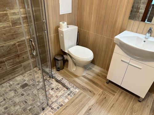 a bathroom with a toilet and a sink and a shower at Belvedere Holiday Club nice place in Bansko