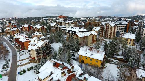 a city with snow covered roofs and buildings at Zlatibor Toska in Zlatibor