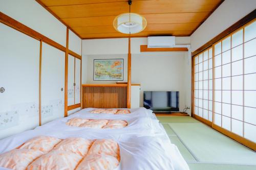Postel nebo postele na pokoji v ubytování Trip7箱根仙石原温泉ホテル
