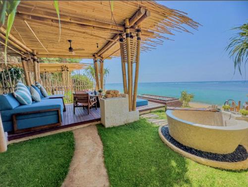 d'une baignoire sur la terrasse avec vue sur l'océan. dans l'établissement Samabe Bali Suites & Villas, à Nusa Dua