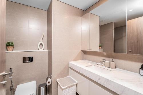 a bathroom with a sink and a mirror at Nasma Luxury Stays - Burj Royale 2BR Apartment in Downtown With Views in Dubai