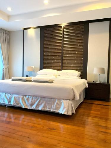 Un dormitorio con una cama grande con un cabecero grande. en Bel Air Cape Panwa Resort Phuket, en Panwa Beach