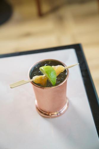 a drink in a pink cup with a lime in it at voco Paris - Porte de Clichy by IHG in Clichy