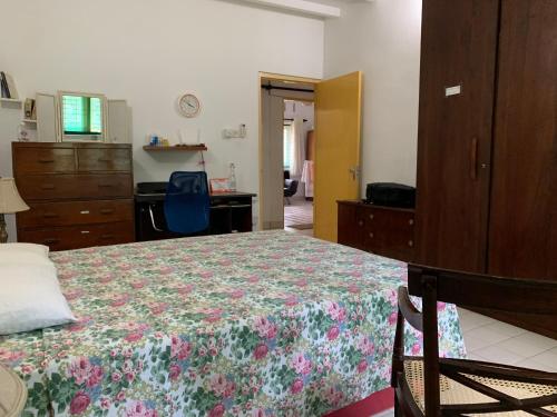 a bedroom with a bed and a dresser and a desk at The Sheltuh : Closer to everything Colombo in Manning Town