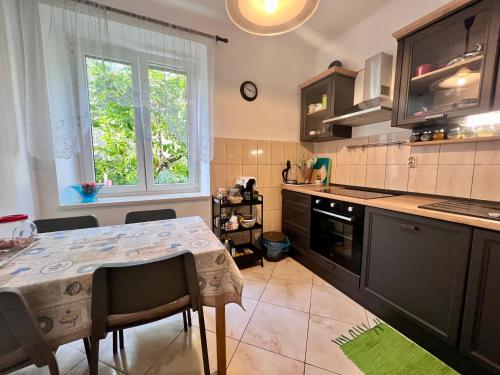a kitchen with a table and a window in it at For All Seasons Apartment in Split