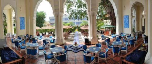 a room with chairs and tables in a building at TripleTree Hotel And Resort Bukittinggi in Bukittinggi