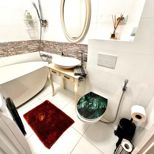 a white bathroom with a sink and a mirror at PENTHOUSE EXCLUSIVE VIEW , Iasi in Iaşi