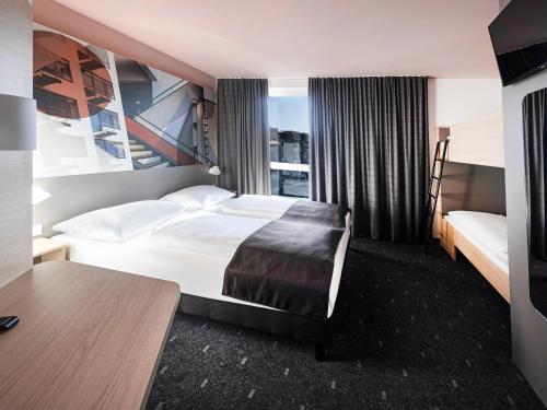 מיטה או מיטות בחדר ב-B&B Hotel Dessau
