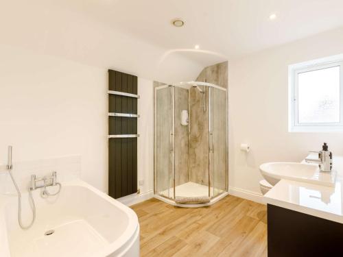 a bathroom with a shower and a tub and a sink at 3 bed in Ross-on-Wye 89313 in Peterstow