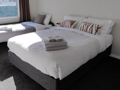um quarto com 2 camas e toalhas em Holiday retreat in the heart of old Cromwell! em Cromwell