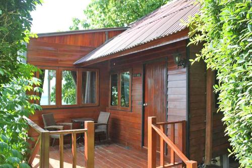 a wooden cabin with a table and chairs on a porch at The Cobble Beach Hotel- Phi Phi Island in Phi Phi Don