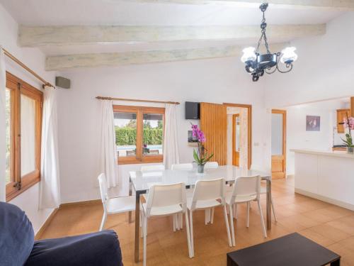 a dining room with a white table and chairs at Can Colet by Sunvillas Mallorca in Pollença
