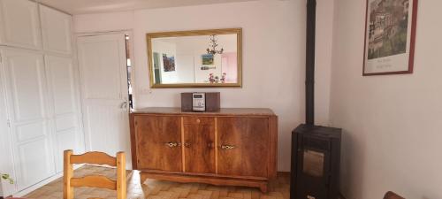 a room with a wooden dresser and a mirror at Gîte Xuritenborda 7 personnes avec vue exceptionnelle sur les montagnes basque, Lits 180 King Size in Ossès