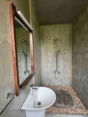 a bathroom with a white sink and a mirror at Wattala Villa- The Guardian Bungalow in Wattala