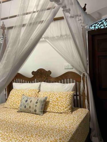 a bedroom with a bed with a canopy at Wattala Villa- The Guardian Bungalow in Wattala