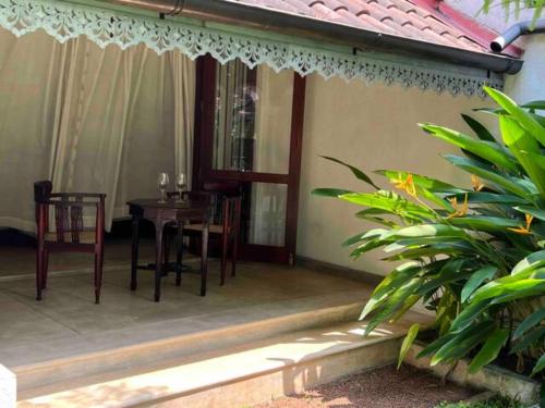 a patio with a table and chairs on a house at Wattala Villa- The Guardian Bungalow in Wattala