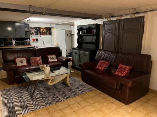 a living room with two leather couches and a coffee table at Appartement privatif de 60 m2 dans belle Maison proche de Disney et Paris in Villiers-sur-Marne