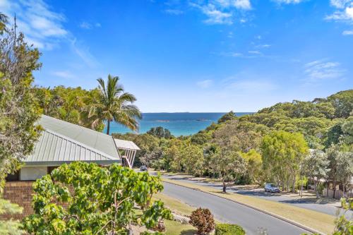 an empty road in front of a house with a view of the ocean at Sea View + Sleeps 8 + 3 mins to Beach in Point Lookout