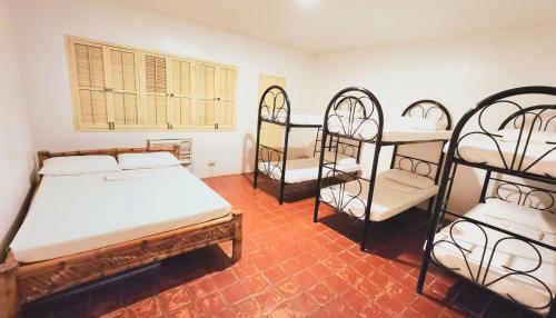 a bedroom with four bunk beds and a window at White House, Batangas in Lian