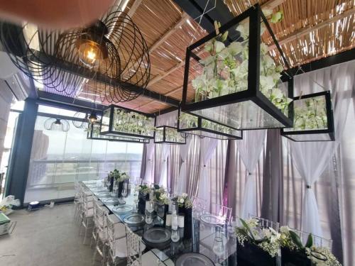 a dining room with a long table with flowers at JTower Royal Suites - The Penthouse - Alefimmoed in Jerusalem