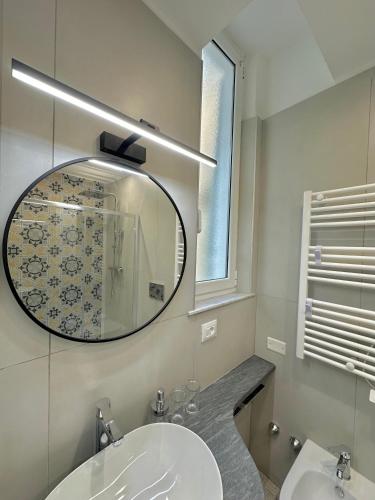 a bathroom with a mirror and a sink at Al Castello 1 in Riomaggiore