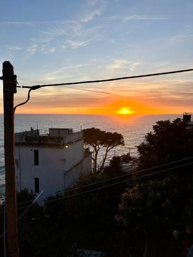 a sunset over the ocean with a power line at Al Castello 1 in Riomaggiore