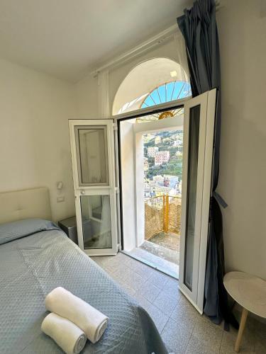 a bedroom with a bed and an open door at Al Castello 1 in Riomaggiore