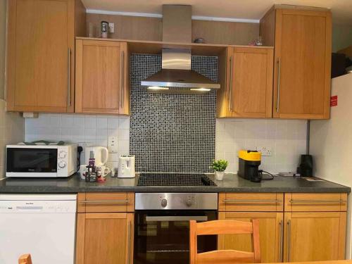 a kitchen with wooden cabinets and a stove top oven at In Dublin's Best Tourist Spot Temple Bar in Dublin