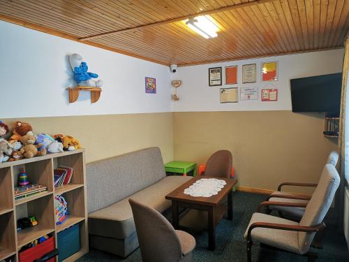 a waiting room with a couch and a table and chairs at Willa Hamernik AGROTURYSTYKA in Tylicz