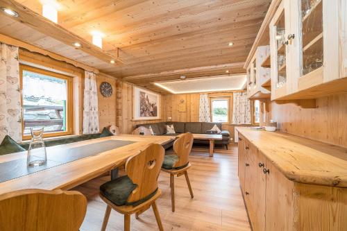 a kitchen with a large wooden table and chairs at Ferienhäuser Tschofen Garfrescha in Sankt Gallenkirch
