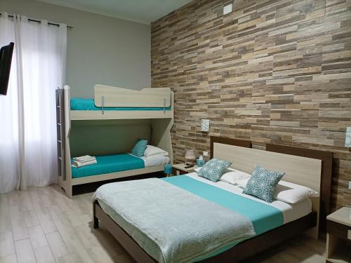 a bedroom with a bed and bunk beds at Domos La Corte Ghibellina in Iglesias
