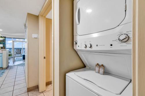 a kitchen with a washer and dryer in a room at Oceanfront 1BR Condo, Your Coastal Escape at Atlantica in Myrtle Beach
