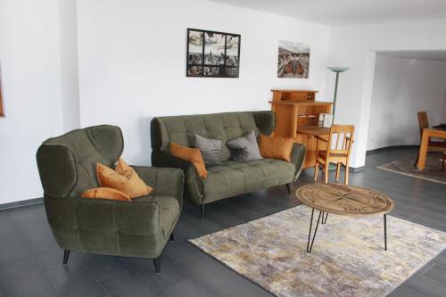 a living room with a couch and a table at Ferienwohnung Flussufer No.12 in Schweich