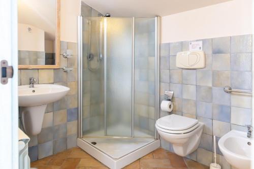 a bathroom with a shower and a toilet and a sink at Casale del Conero in Porto Recanati