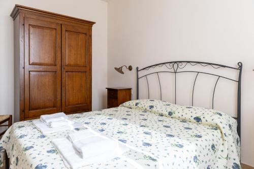 a bedroom with a bed with two towels on it at Casale del Conero in Porto Recanati