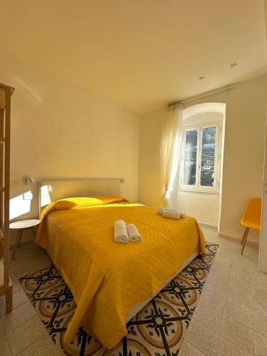 a bedroom with a bed with two towels on it at Al Castello 1 in Riomaggiore