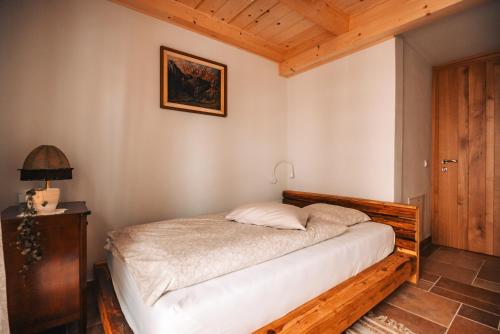 a bedroom with a bed with a wooden frame at Posest Kunigunda in Šmartno v Rožni Dolini