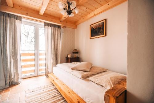 a bedroom with a bed and a large window at Posest Kunigunda in Šmartno v Rožni Dolini