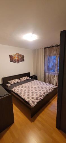 a bedroom with a large bed in a room at Alia in Oradea
