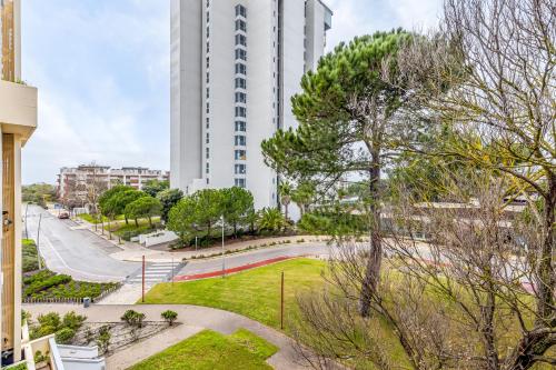 a tall white building with a park in front of it at Torralta in Carvalhal