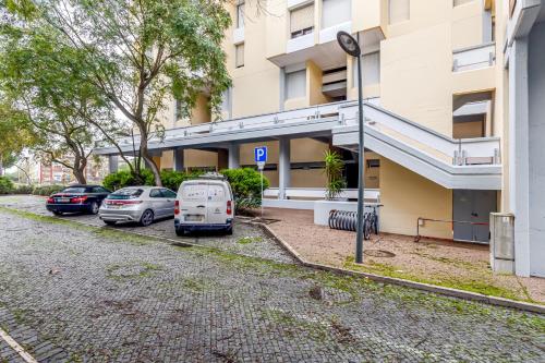 a parking lot with cars parked in front of a building at Torralta in Carvalhal